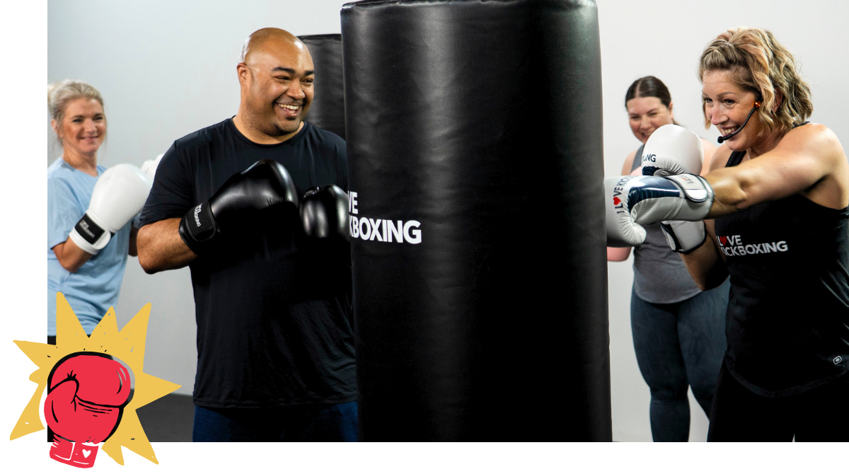4 people happily punching bags and participating in a killer I Love Kickboxing workout